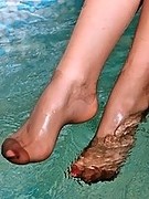 Sweet teen babe showing her long legs in wet brown pantyhose
